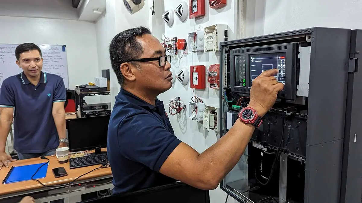 Students learning to install and configure FDAS equipment during a practical training session